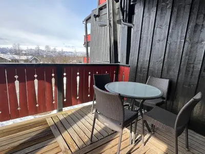 a patio with a table and chairs on a balcony at Appartment at Stølstunet in Beitostølen in Beitostøl