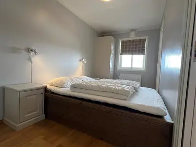 a bedroom with a large bed with a night stand at Appartment at Stølstunet in Beitostølen in Beitostøl