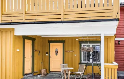 a porch with two doors and a table and chairs at Gorgeous Home In Bjorli With Wifi in Bjorli