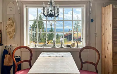 a dining room with a table and chairs and a window at Beautiful Home In Sjusjøen With Wifi in Sjusjøen