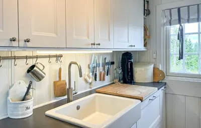 a white kitchen with a sink and a window at Beautiful Home In Sjusjøen With Wifi in Sjusjøen