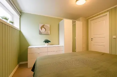 a bedroom with a bed and a white door at Leilighet sentralt i Bud in Bud