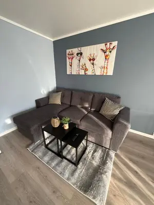 a living room with a couch and a table at Apartment by the center of Ålesund in Ålesund