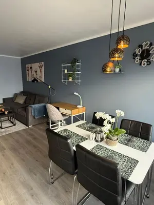a living room with a table and chairs and a couch at Apartment by the center of Ålesund in Ålesund