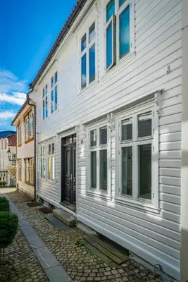 a white building with a door on a street at Bergen style Apt I Cozy street I Easy check in in Bergen