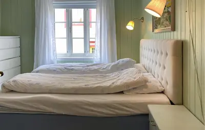 a bed with two pillows on it in a bedroom at Stunning Home In Runde With Wifi in Runde