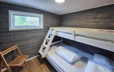 a room with two bunk beds and a window at Awesome Home In Sletta With Wifi in Sletta