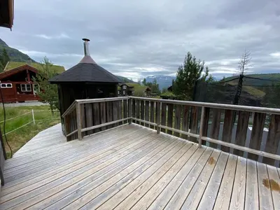a large wooden deck with a gazebo at Cabin for rent in scenic Stryn in Stryn