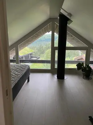 a room with a bed and a large window at Cabin for rent in scenic Stryn in Stryn