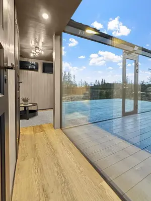 a pivot door in a house with a view of a pool at Fela Mirror Cabin Designer Hideaway 1000 m Above Sea Level in Aurdal
