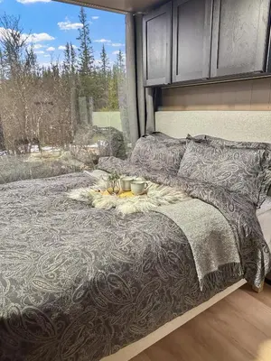 a bed with a tray of food on top of it at Fela Mirror Cabin Designer Hideaway 1000 m Above Sea Level in Aurdal