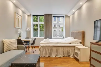 a living room with a bed and a couch at Fløyen Apartments in Bergen