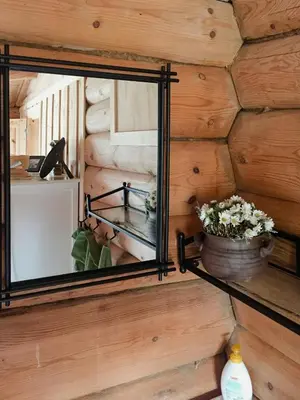 a mirror on the wall of a tiny house at Modern Log Cabin By Hardangervidda in Dagali