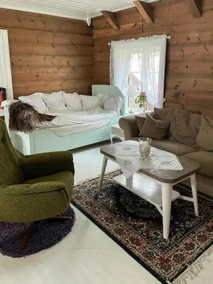 a living room with a couch and a coffee table at Historic Farm With Sea View Over Bjørnefjorden