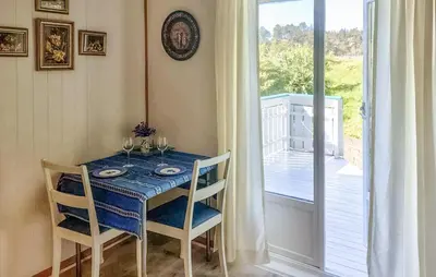 a dining room with a blue table and chairs at Beautiful Home In Urangsvåg in Rolvsnes