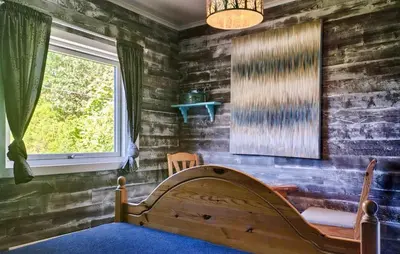 a bedroom with a wooden bed and a window at Beautiful Home In Urangsvåg in Rolvsnes