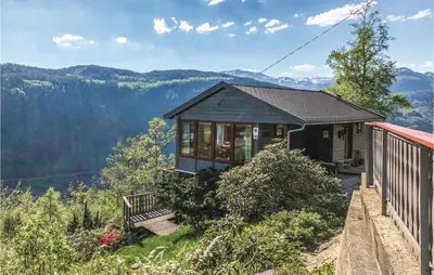 a house on a hill with a view of the mountains at Stunning Home In Steinstø With Wifi in Steinstø