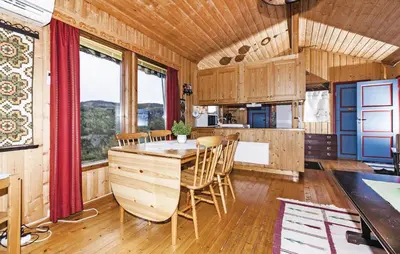a kitchen and dining room with a table and chairs at Stunning Home In Steinstø With Wifi in Steinstø