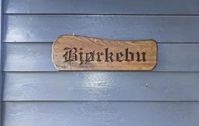 a wooden sign on the side of a house at Stunning Home In Steinstø With Wifi in Steinstø