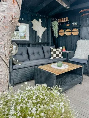 a living room with a couch and a table at Idyllic Cabin By The Water In Hessdalen in Ålen