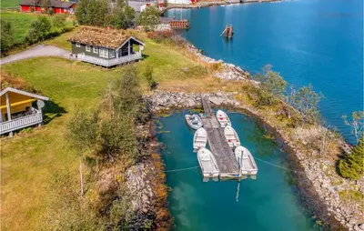 an aerial view of a house and a dock with boats at Stunning Home In Fjærland in Fjarland