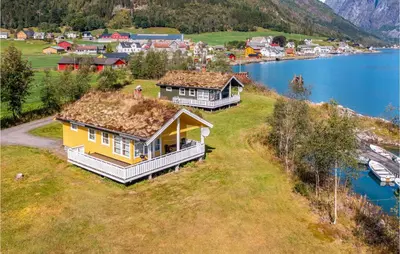 an aerial view of two houses on a hill next to a lake at Gorgeous Home In Fjærland in Fjarland