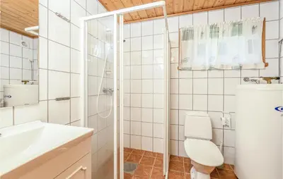 a bathroom with a toilet and a sink and a shower at Gorgeous Home In Fjærland in Fjarland