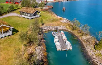 an aerial view of a house and a dock with boats at Gorgeous Home In Fjærland in Fjarland