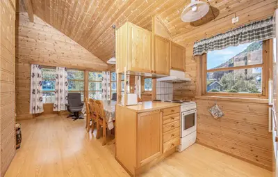 a kitchen and dining room with a table in a cabin at Gorgeous Home In Fjærland in Fjarland
