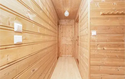 a wood paneled sauna with a wooden wall at Awesome Home In Fjærland in Fjarland