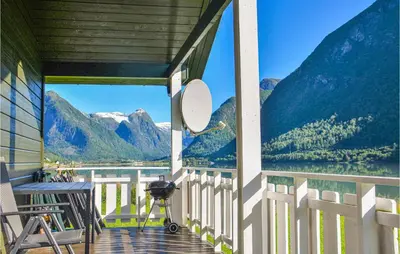 a porch with a view of a lake and mountains at Awesome Home In Fjærland in Fjarland