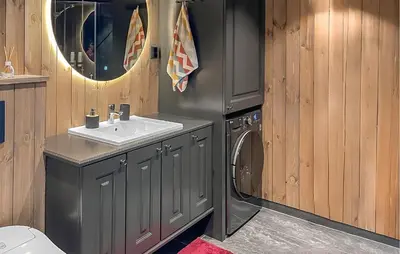 a bathroom with a sink and a washing machine at 2 Bedroom Awesome Home In Engerdal in Kvisla