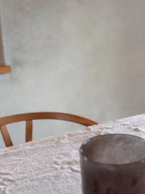 a table with a white table cloth and a chair at Large and family friendly cabin near Langedrag in Tunhovd
