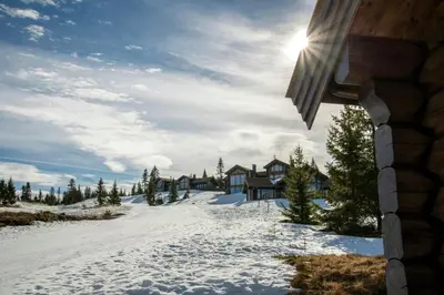 a winter view of a house in the snow at Luxurious Log Cabin At Mostertoppen in Øyer