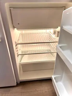 an empty refrigerator with its door open and its shelves at Modern cabin in amazing hiking area! in Gol