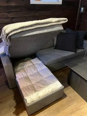 a bed and a couch in a room at Modern cabin in amazing hiking area! in Gol