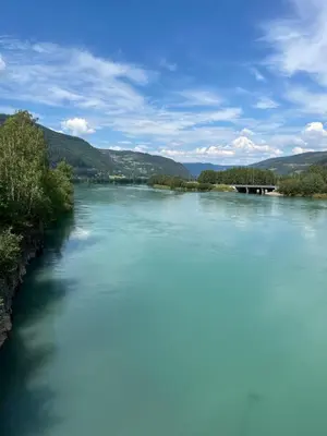 a river with blue water and mountains in the background at Kvitfjell mountain in Strande