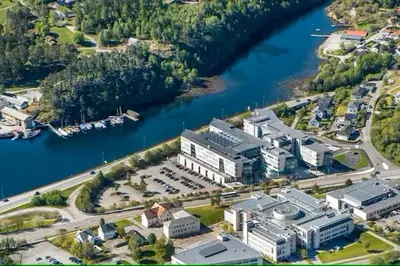 an aerial view of a large building next to a river at Ålesund Campus Apartments in Ålesund