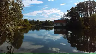 a view of a river with a house and a building at Ålesund Campus Apartments in Ålesund