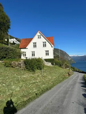 a white house on the side of a road at Panorama Stryn in Stryn