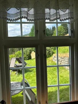 an open window with a view of a yard at Panorama Stryn in Stryn