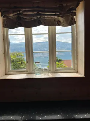 an open window with a view of the ocean at Panorama Stryn in Stryn