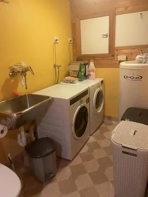 a kitchen with a washing machine and a sink at Panorama Stryn in Stryn