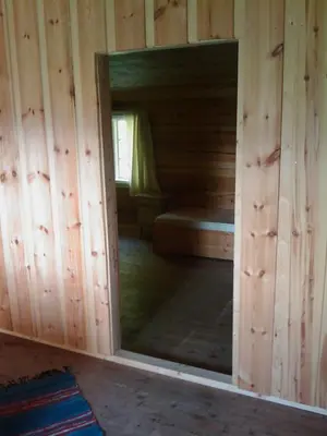 a room with a mirror in a wooden cabin at Gravraakstuggu in Storneve