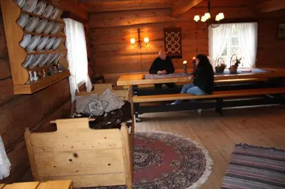 two people sitting at a table in a cabin at Gravraakstuggu in Storneve
