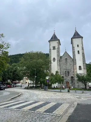 two towers on top of a building on a street at Bergenshus rett ved Bryggen i Bergen in Bergen