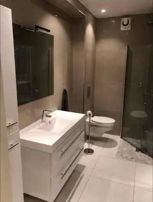 a bathroom with a white sink and a toilet at Moderne Leilighet midt i Bykjernen in Bergen