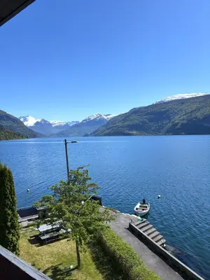 a view of a lake with a boat in the water at Faleide Grandview in Stryn
