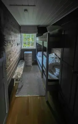 a room with two bunk beds and a window at Large Familycabin In Fageråsen in Trysil