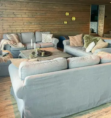 a living room with two couches and a table at Large Familycabin In Fageråsen in Trysil